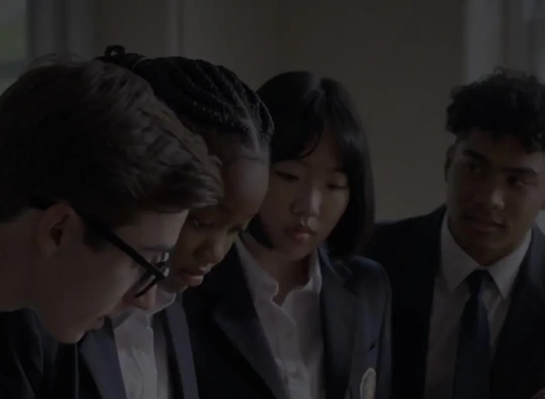 A student team huddled over their venture plan